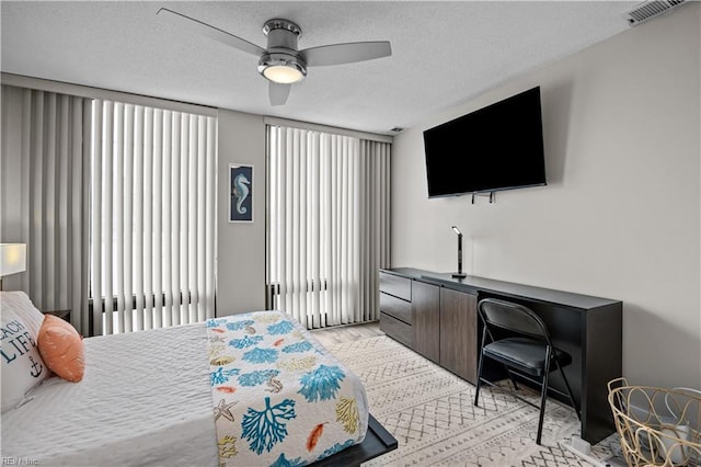 bedroom with visible vents, multiple windows, and a textured ceiling