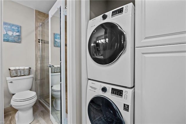 washroom with laundry area and stacked washer / drying machine