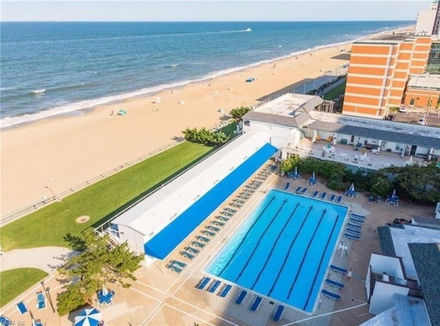 bird's eye view featuring a water view and a beach view