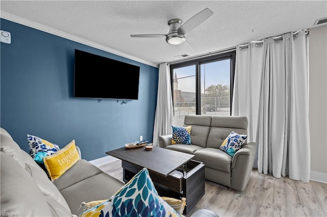 living room with crown molding, wood finished floors, a ceiling fan, and a textured ceiling