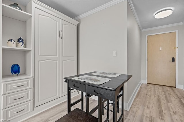 foyer featuring light wood finished floors, baseboards, and ornamental molding