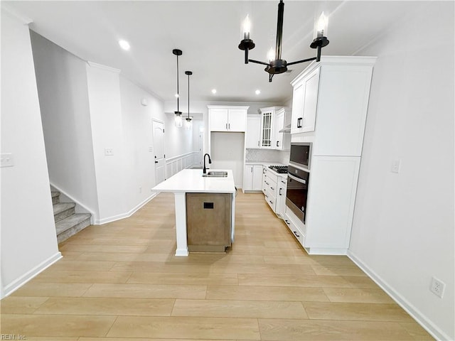 1541 Waltham Ln, Newport News, VA 23608 - kitchen with oven, light wood finished floors, a kitchen island with sink, recessed lighting, and gas cooktop