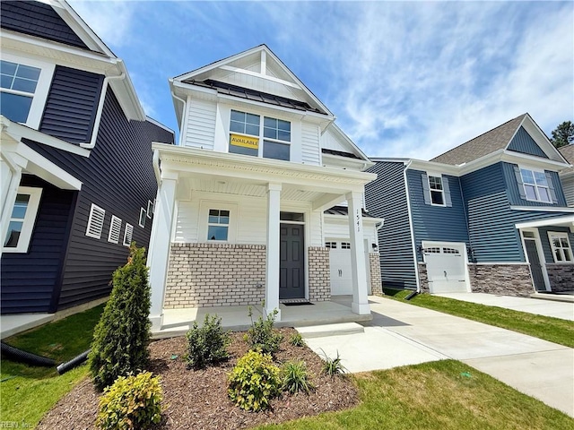1541 Waltham Ln, Newport News, VA 23608 - view of front of house with a porch, driveway, a garage, board and batten siding, and stone siding