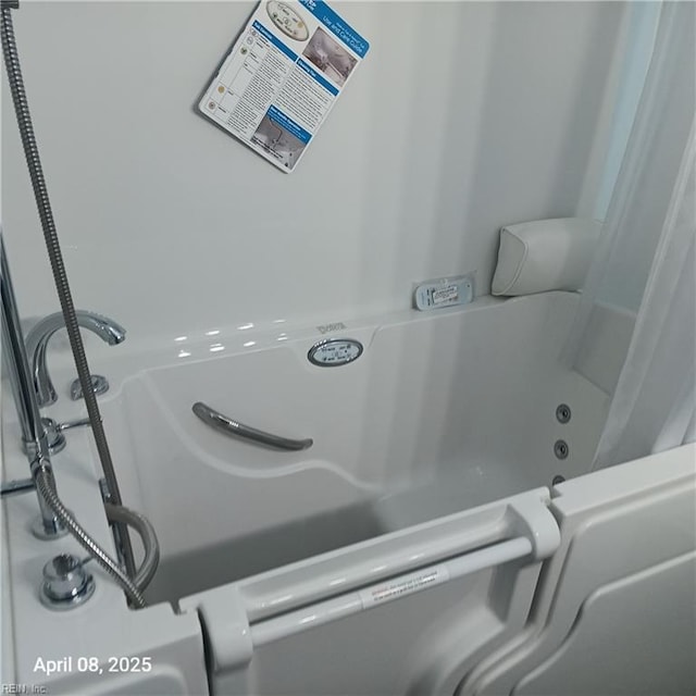 room details with a shower with shower curtain and a bathing tub