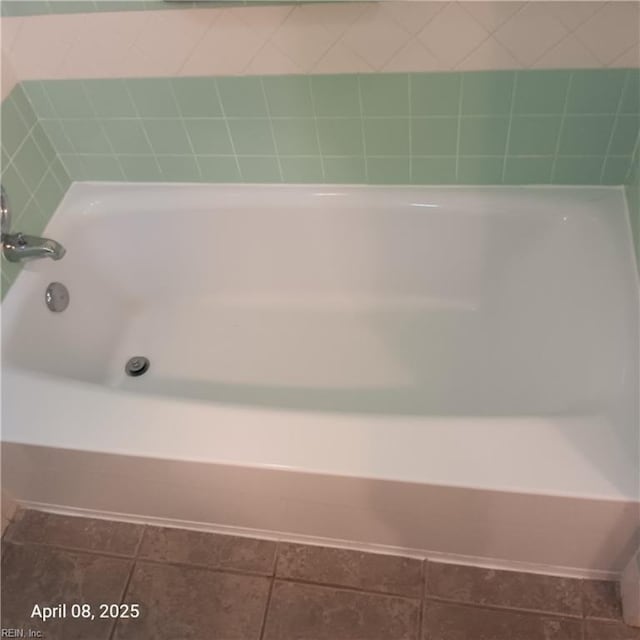 full bathroom featuring a bathing tub and tile patterned flooring