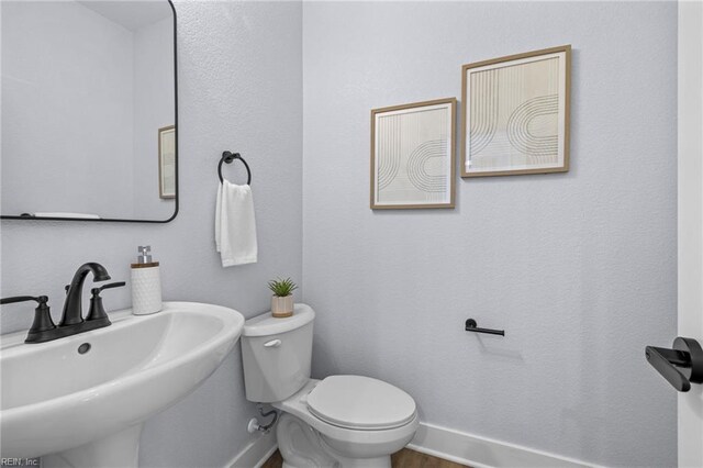3545 Winston Ave, Virginia Beach, VA 23456 - bathroom featuring baseboards, a sink, toilet, and wood finished floors