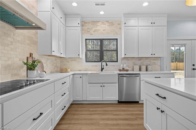 3545 Winston Ave, Virginia Beach, VA 23456 - kitchen with visible vents, wall chimney exhaust hood, black electric cooktop, stainless steel dishwasher, and a sink