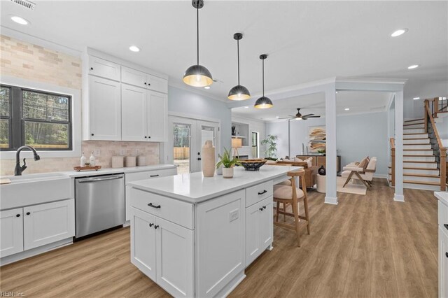 3545 Winston Ave, Virginia Beach, VA 23456 - kitchen with stainless steel dishwasher, light wood finished floors, light countertops, and white cabinetry