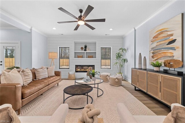 3545 Winston Ave, Virginia Beach, VA 23456 - living room with dark wood-style floors, a ceiling fan, ornamental molding, and a glass covered fireplace