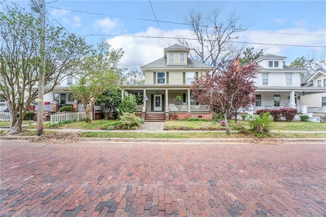 view of front facade with fence and covered porch
