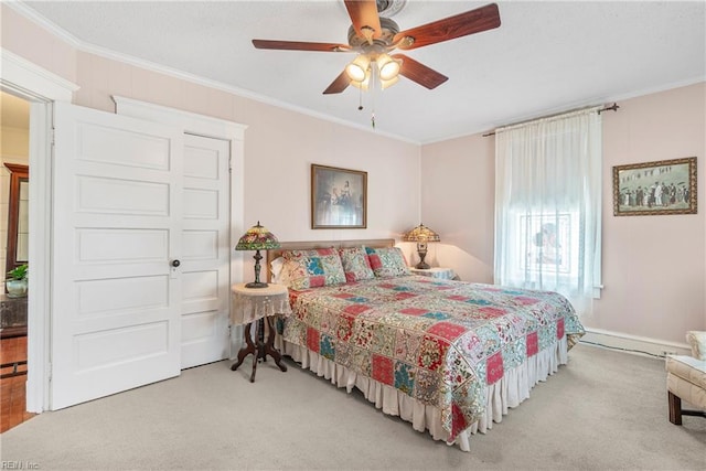carpeted bedroom featuring crown molding and a ceiling fan