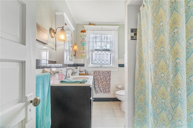 bathroom featuring ornamental molding, toilet, tile walls, vanity, and tile patterned flooring