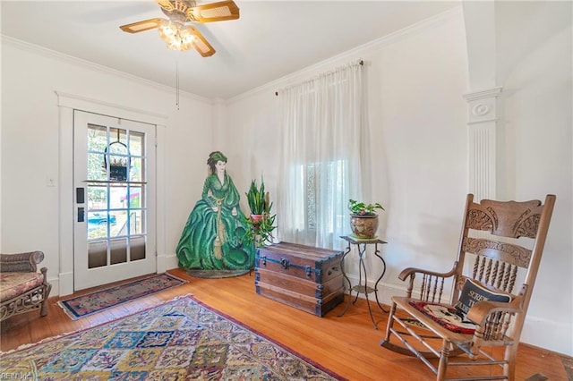 sitting room featuring crown molding and wood finished floors