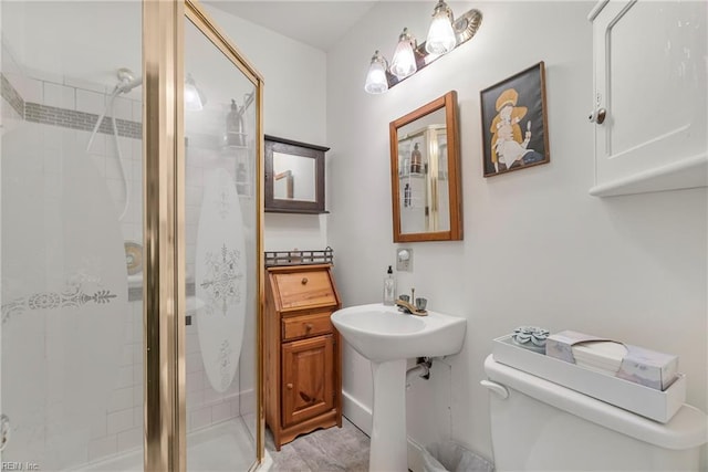 bathroom featuring toilet and a stall shower