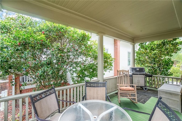deck featuring a grill and outdoor dining space