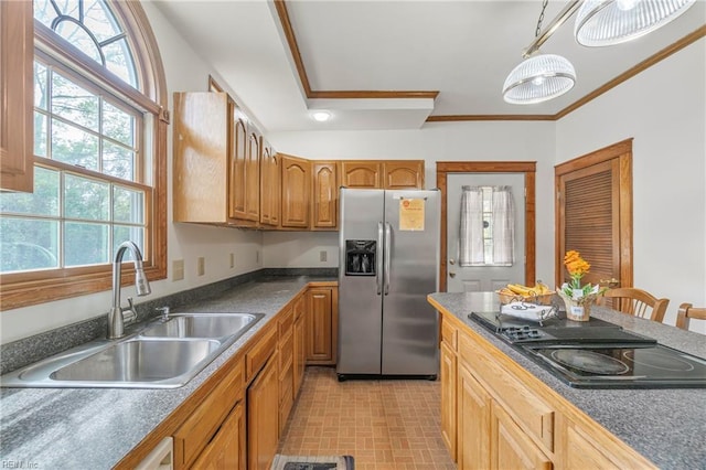 kitchen with stainless steel refrigerator with ice dispenser, black electric cooktop, a sink, ornamental molding, and dark countertops