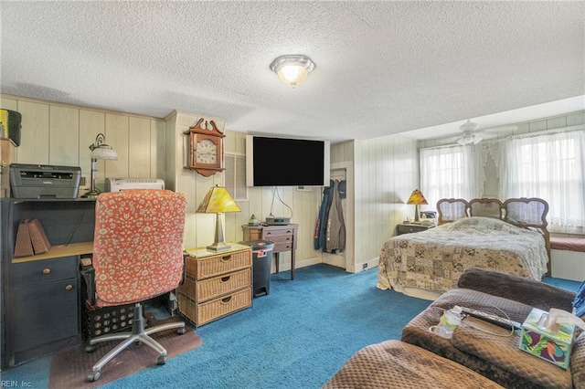 bedroom with carpet flooring, a textured ceiling, and baseboards