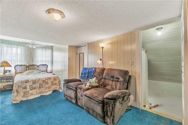 bedroom with a textured ceiling and carpet floors