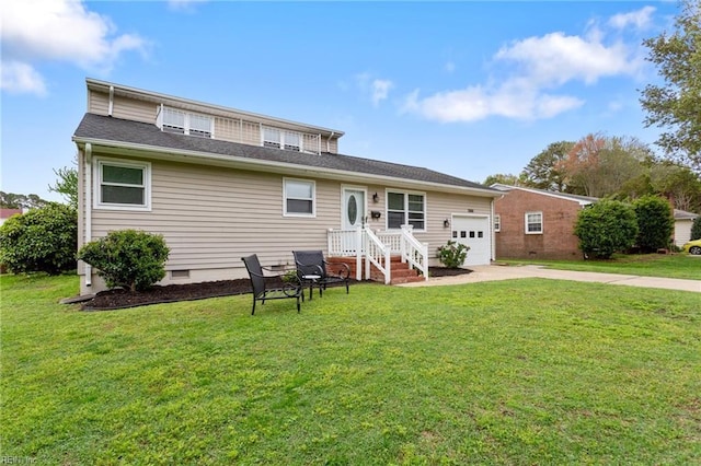 back of property with crawl space, a yard, a garage, and concrete driveway