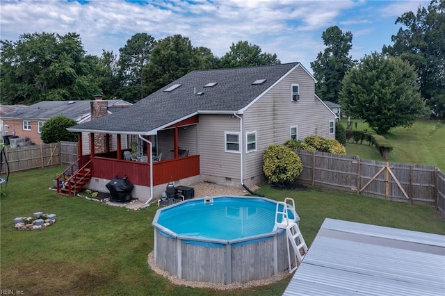 view of pool featuring a yard, a fenced backyard, a fenced in pool, and a deck