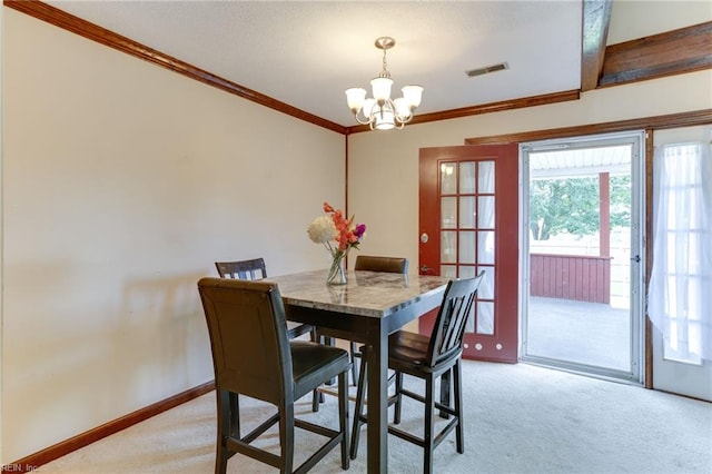 dining room featuring crown molding, baseboards, an inviting chandelier, and light carpet