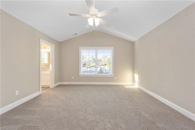 spare room featuring ceiling fan, baseboards, lofted ceiling, and carpet floors