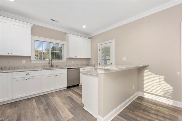 kitchen featuring white cabinets, stainless steel dishwasher, a sink, and visible vents