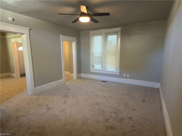 unfurnished bedroom with visible vents, baseboards, a ceiling fan, and carpet