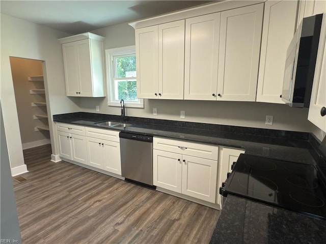 kitchen with a sink, dark wood-style floors, black / electric stove, white cabinetry, and stainless steel dishwasher