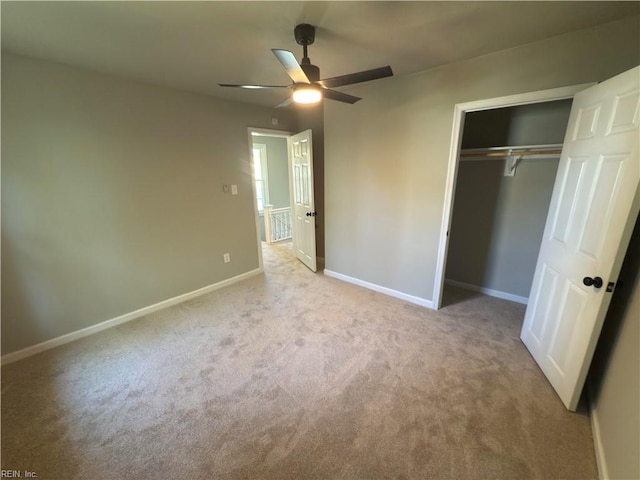 unfurnished bedroom with a closet, carpet flooring, baseboards, and a ceiling fan