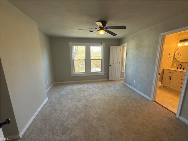 unfurnished bedroom featuring light carpet and baseboards