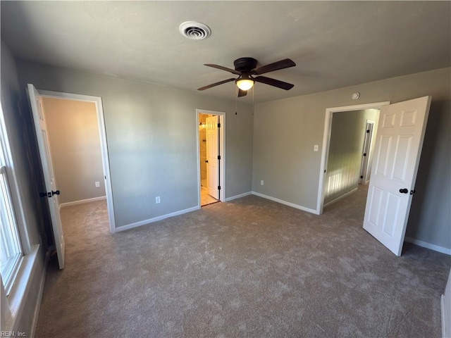 unfurnished bedroom featuring carpet flooring, visible vents, and baseboards