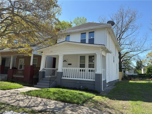 traditional style home featuring a front lawn and covered porch