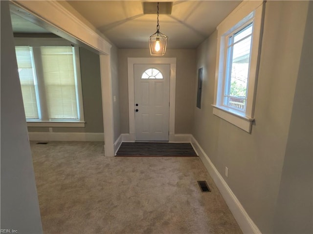 foyer entrance featuring electric panel, baseboards, carpet, and visible vents