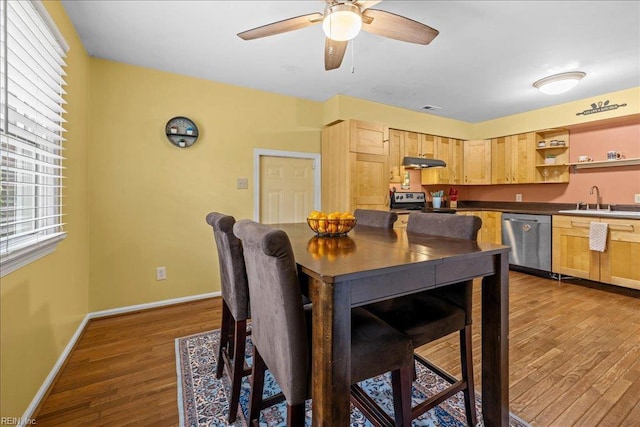 dining room with ceiling fan, baseboards, visible vents, and wood finished floors
