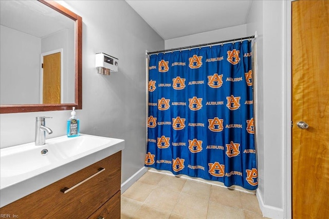 bathroom with tile patterned flooring, vanity, baseboards, and a shower with curtain