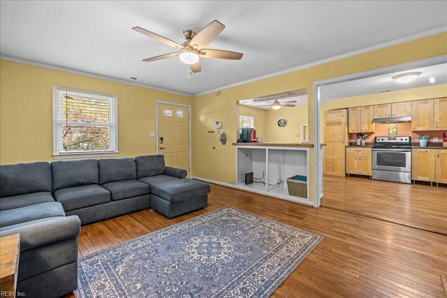 living room featuring ornamental molding, ceiling fan, and hardwood / wood-style flooring