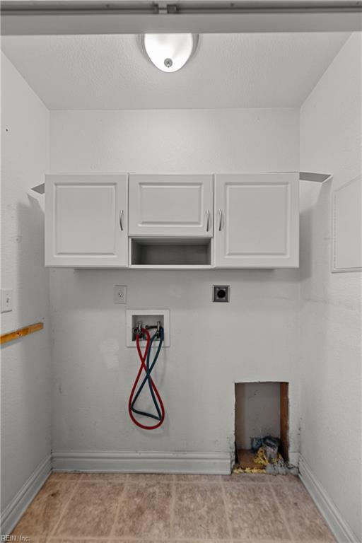 laundry area with baseboards, hookup for an electric dryer, washer hookup, and cabinet space