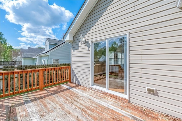 wooden terrace featuring fence
