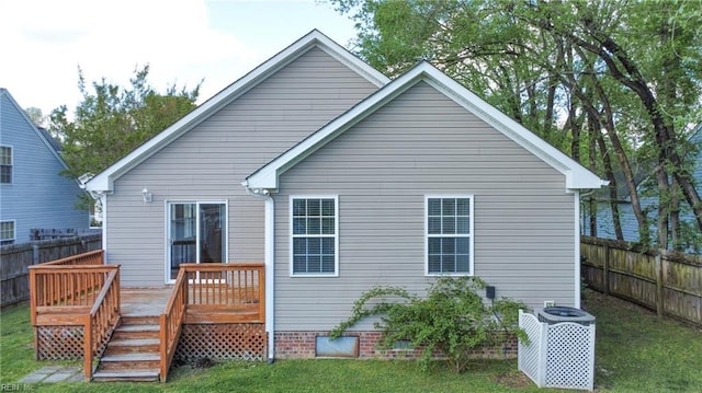 rear view of house featuring central air condition unit, a yard, fence, and a deck