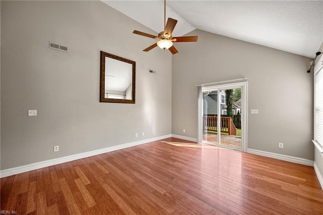 spare room featuring hardwood / wood-style floors, baseboards, a ceiling fan, and visible vents