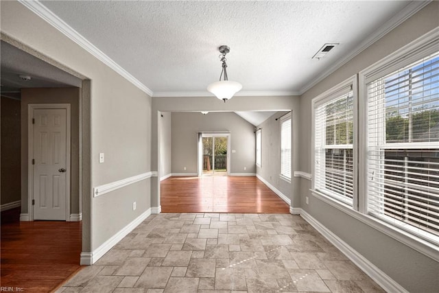 foyer entrance featuring a healthy amount of sunlight, stone finish floor, baseboards, and visible vents