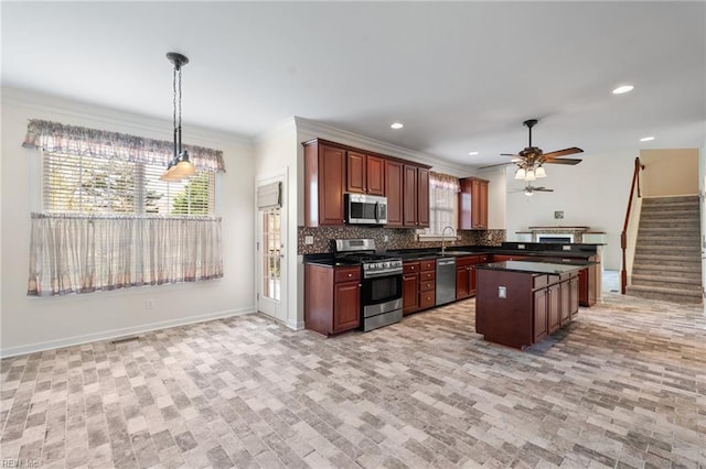 kitchen featuring a sink, dark countertops, a ceiling fan, stainless steel appliances, and backsplash