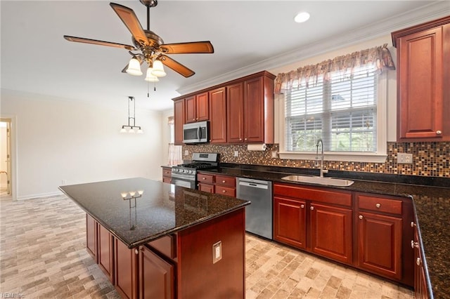 kitchen with a center island, a sink, crown molding, stainless steel appliances, and decorative backsplash
