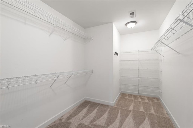 walk in closet with carpet floors and visible vents