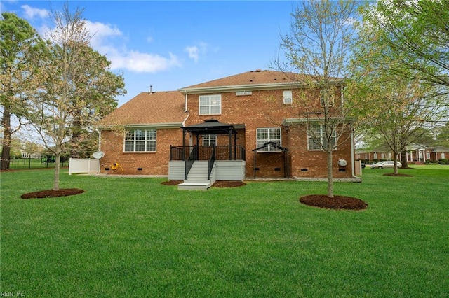 back of house with brick siding, a lawn, and crawl space