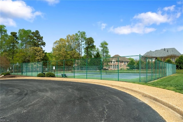 view of sport court featuring fence