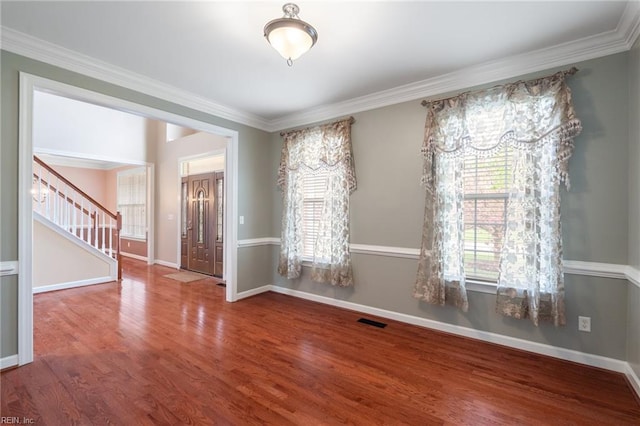unfurnished room featuring stairs, visible vents, baseboards, and wood finished floors