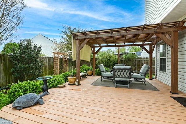 deck with a pergola, outdoor dining area, and a fenced backyard