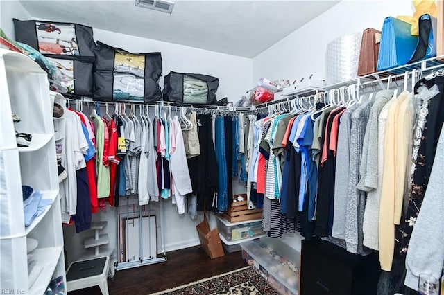 walk in closet featuring wood finished floors and visible vents